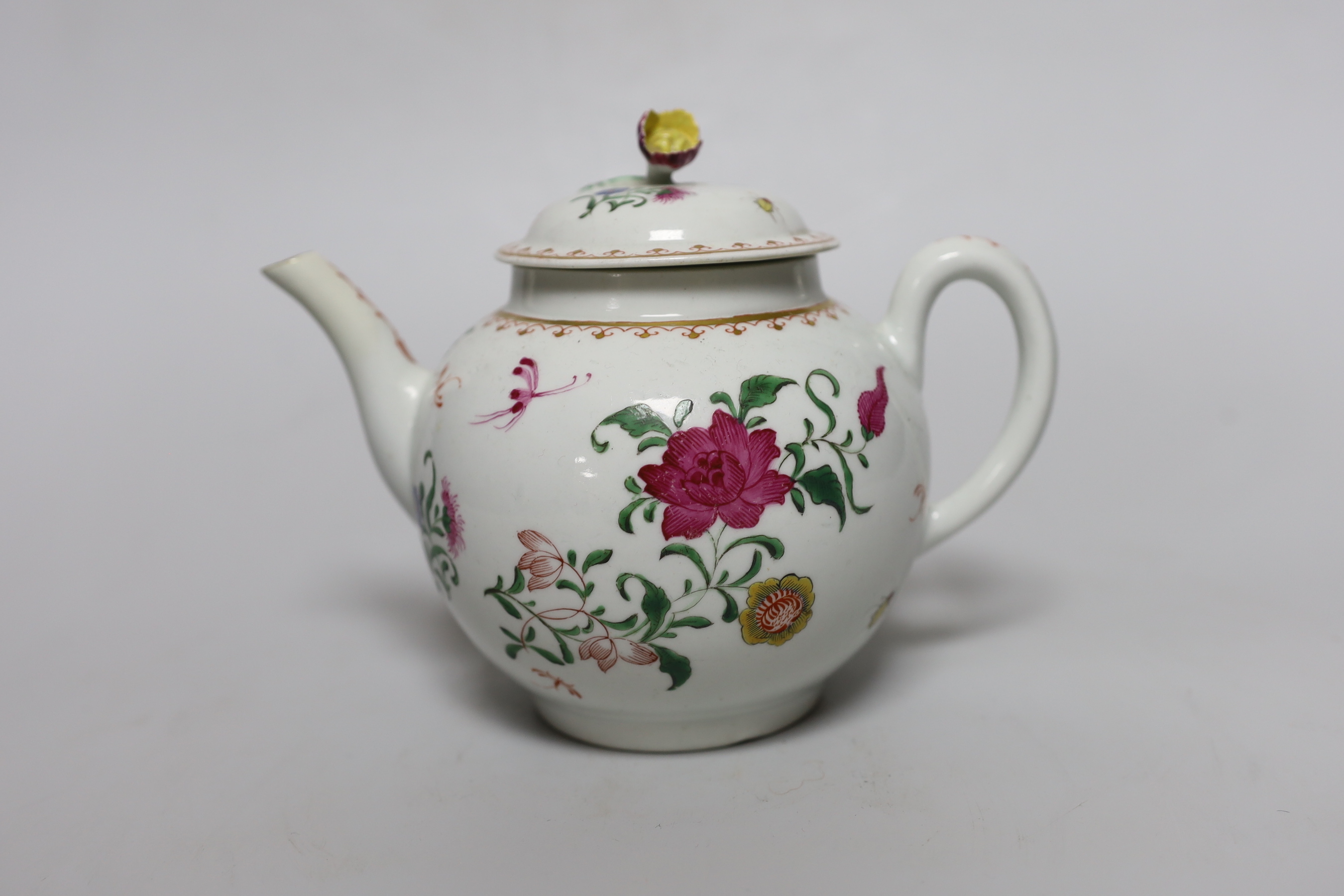 A Worcester teapot and cover, painted with Chinese style flowers and winged insects, c.1770, 14cm tall